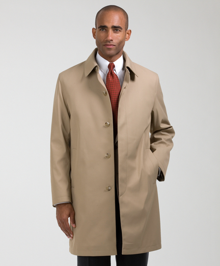 A blend of cotton and polyester with a zip out lining for added versatility.  Dry clean.  Imported.