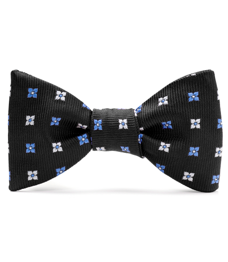 Pure silk woven in England. Fabric is treated to repel liquids and stains. Self-tie bow. Dry clean.Made in the USA.