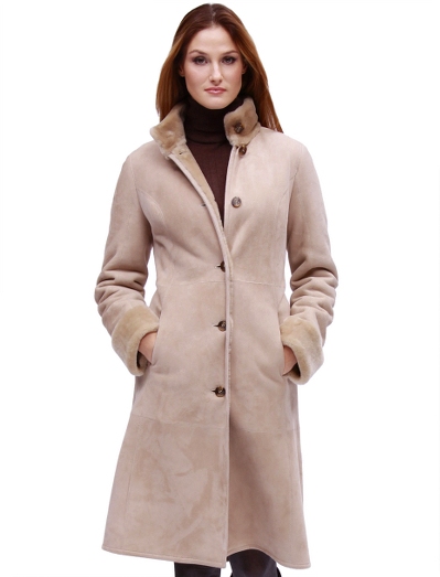 Luxuriously warm shearling coat with turn back cuffs and mock collar. Professional clean. Imported.