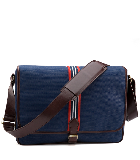 Durable cotton canvas bags with web stripe details and leather trim. Brass hardware. Adjustable shoulder strap and buckle flap closure. 16" x 12" x 3".
