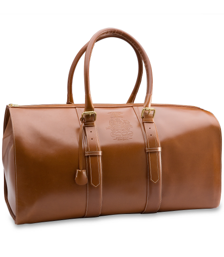 Vegetable tanned leather with shiny brass hardware contrast stitching, interior pockets, reinforced handles vintage logo, twill lining. 21" x 10" x 11". Made in Italy.