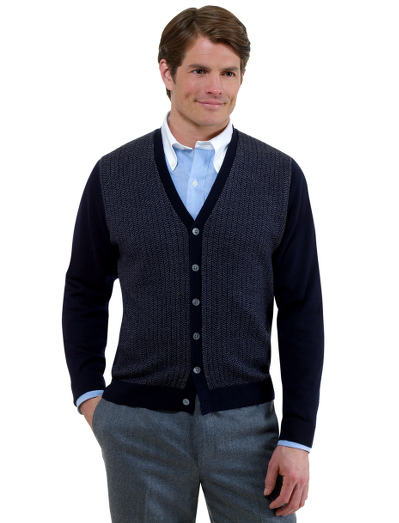 Extrafine Italian merino.  An excellent layer in a classic cardigan button front body with a herringbone pattern. Knit lined pockets. Fully fashioned. Dry clean. Imported.