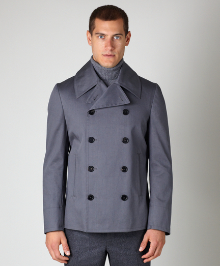 Pure cotton mackintosh. Full canvas construction. Genuine horn buttons. Locker loop at back neck. Cupro, cotton and polyester blend signature stripe lining. Coat is shipped ready to be altered with cut button holes. Dry clean. Made in Italy.