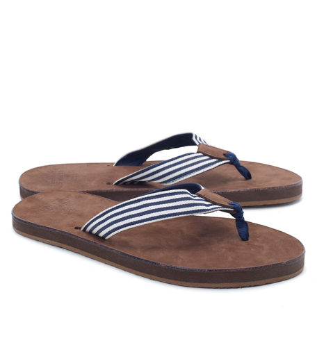 Leather foot bed with ribbon detailed thong strap. Made in the USA.