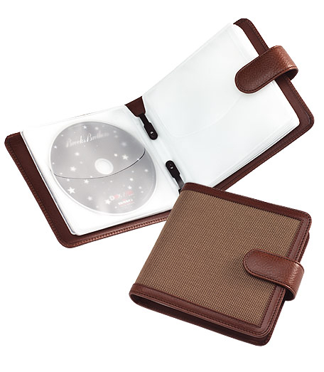 Distinctive CD case is crafted and trimmed in genuine leather from Florence, Italy. Overlaid with oxford cloth inspired by the famous Brooks Brothers oxford cloth shirt. Holds 32 CD's.