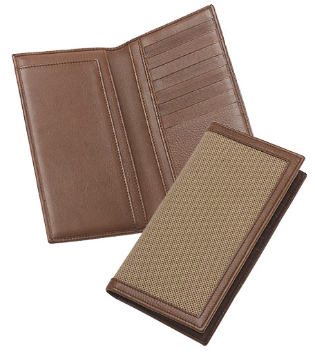 Our oxford checkbook cover is inspired by the classic Brooks Brothers oxford shirt. Trimmed in leather from Florence, Italy. Navy Golden Fleece jacquard-lined interior has eight credit card slots. Embossed Brooks Brothers insignia. 7" x 3 1/2". Made in Italy.