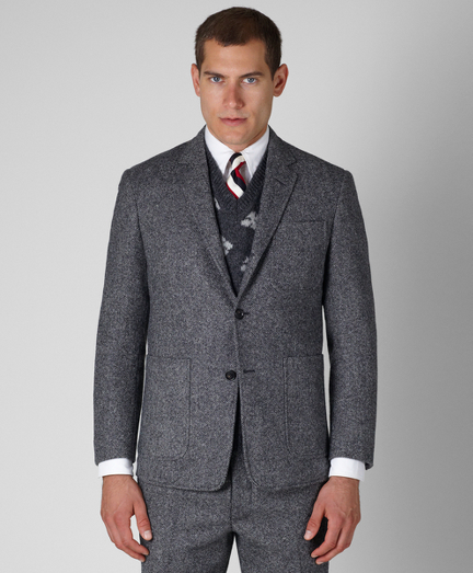 Pure wool tweed. Three-button, center vent with three patch pockets. Genuine horn buttons. Jacket sleeves are lined in Bemberg and unfinished;  signature cuff is two button holes. Full canvas construction. Locker loop at back neck. Jacket is half-lined in signature stripe lining of cotton and modelblend. Dry clean. Made in the USA.