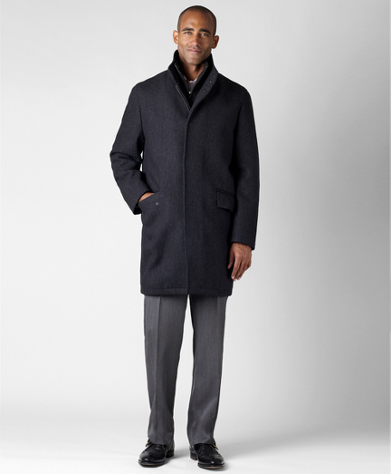 Modern top coat styling in pure wool. Lined in 100% pure Bemberg. Zip-front with zip-out interior vest. Dry clean. Imported.