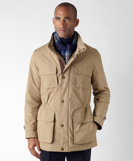 Nylon lined with 100% twill Bemberg lining. Zip and snap front with drawstring waist and hidden hood. Action back for added comfort. Faux suede details. Multiple interior pockets. Dry clean. Imported.