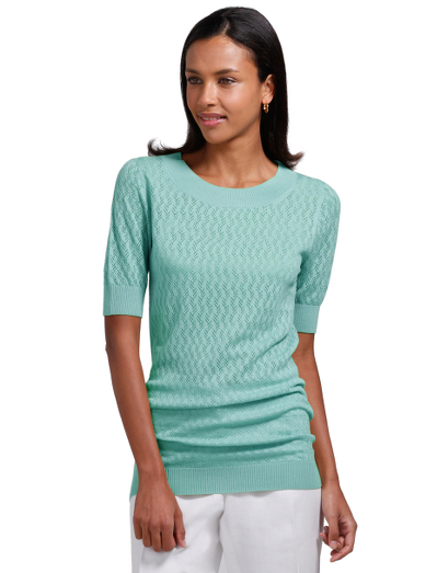 Merino/silk. Crewneck. Tunic length. Ribbed trim at neck, cuff and hem. All over pointelle. Dry clean. Imported.