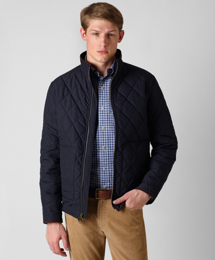 Short quilted bomber style in polyester with fleece lining. Zip front and faux suede details.  Dry clean. Imported.