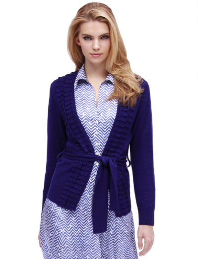Extrafine Italian merino wool. V-neck. Rib trim at hem and cuffs. Self belt. Ruffles along neckline and down center front. Dry clean. Imported.