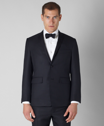 Pure wool twill. Three-button jacket with double back vent and silk faille on lapel. Lined in a cotton and modal blend. Silk faille covered buttons. Locker loop at back of neck. Jacket sleeves are unfinished, signature cuff is two button holes and lined in Bemberg. Full canvas construction. Locker loop at back neck. Dry clean. Made in the USA.