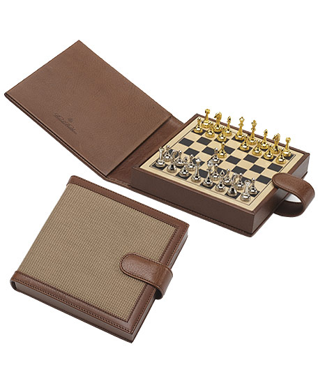 Distinctive game set crafted and trimmed in genuine leather from Florence, Italy and overlaid with oxford cloth inspired by the famous Brooks Brothers oxford cloth shirt. Features backgammon and chess. 5.5" x 5.5".
