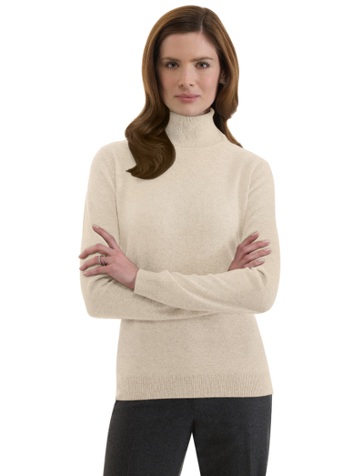 Italian cashmere. Rib trim at cuffs and hem. Dry clean.  Imported.