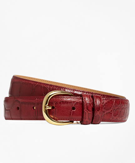 American alligator. Leather lined. Brass hardware. 1 1/8" wide. Made in Italy.