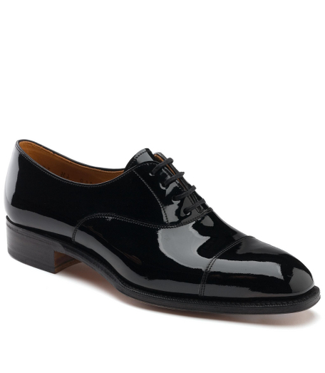 Patent leather calfskin. Handmade. Leather sole. 2" heel. Leather lined. Captoe detail with lace up. Made in Spain.