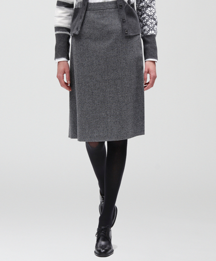 Pure wool with a 100% Bemberg lining. Herringbone pattern. Zipper closure. Dry clean. Imported.