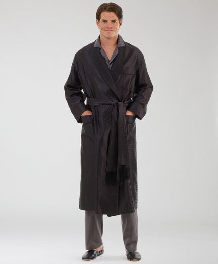 Handcrafted in England. Pure finely woven silk in a subtle tonal paisley. Black quilted silk shawl collar and patch pockets. Silk satin cord piping. Silk lining. Self-fabric belt with tassels. Dry clean only.