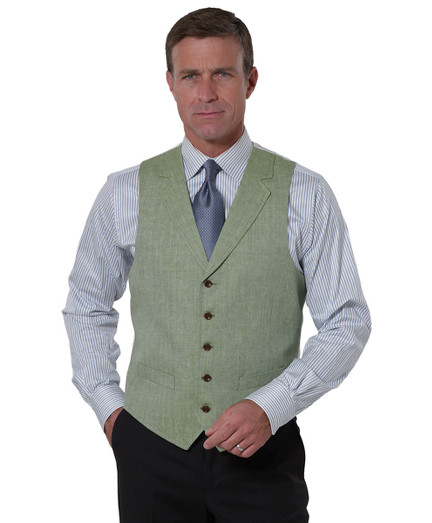 Wool and linen blend woven in England. Five-buttons with lapel. Two welt pockets. Dry clean. Imported.