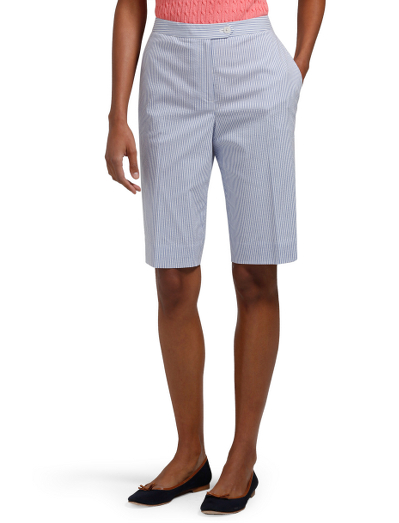 Cotton/lycra. Plain front. Mother-of-pearl buttons. Tab front closure with hidden button at inside waistband. Front slant pockets. Back button through flap pockets. Center front zip. 12" inseam. Dry clean. Imported.