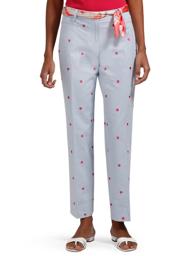 Cotton. Pink embroidered sea shells on blue/white seersucker. Our Natalie slim fit capri pants. Plain front. Mother-of-pearl buttons. Hidden inside button and hook and bar at waist closure. Center front zipper. Fully lined in lightweight cotton voile. Front and back besom pockets. Dry clean. Imported.