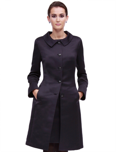 Polyester. Portrait collar. Black enamel buttons at center front and on back inset belt. Straight sleeves with slits at cuffs. Unlined with open bound seams in Bemberg. Fabric woven in Italy. Dry clean. Imported.