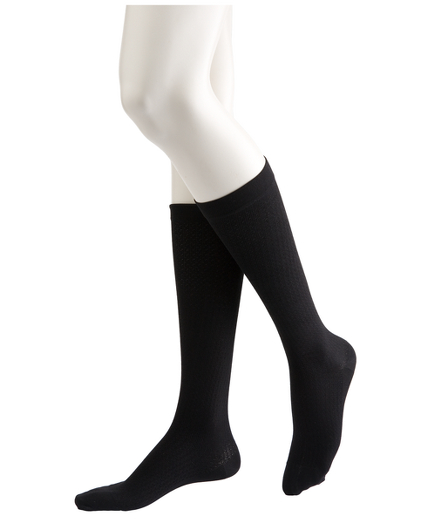 95% nylon/5% spandex. Soft and comfortable. Energizes tired legs and stays in place all day. Machine wash.