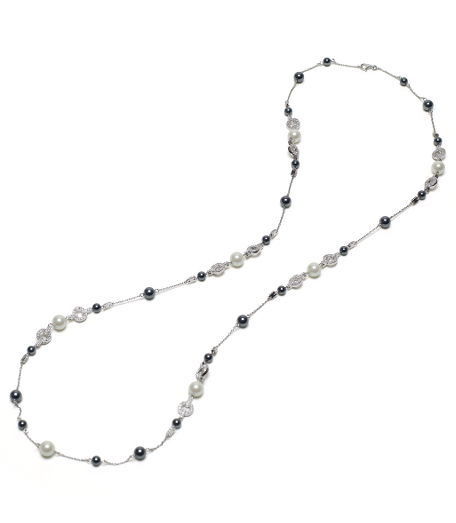Beautiful 36" sterling silver illusion necklace of multi-sized black and white glass. Pearls interspersed with pave crystal stations. Presented in a gift box. Imported.