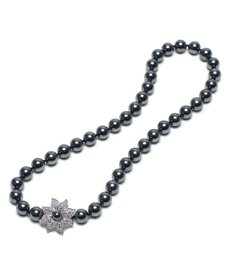 Add an elegant finishing touch to your ensemble.10mm black glass pearls handknotted with beautiful sterling silver pave crystal flower clasp. Flower clasp features a 6mm black glass pearl and is a strong magnetic closure. 18". Presented in a gift box. Imported.