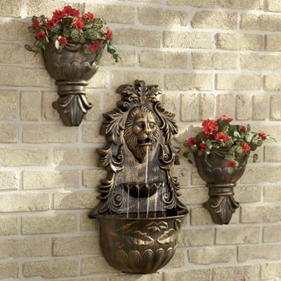 antiqued lion s head wall fountain with planters