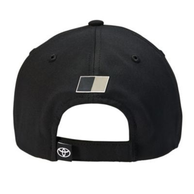 Back view of a black baseball cap with a sleek silver-and-black logo above the opening and an adjustable strap featuring a Toyota tag.