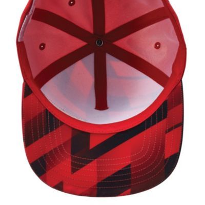Inside view of a red baseball cap with six ventilated panels and a red-and-black geometric pattern on the brim