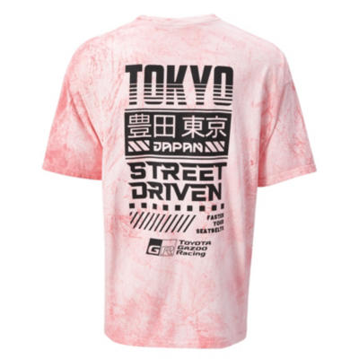 A pink tie-dye T-shirt with black and white graphic text on the back, including ""TOKYO,"" ""JAPAN,"" and ""STREET DRIVEN.""