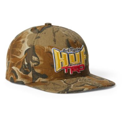 A camouflage cap with ""HUF TRD"" embroidered on the front.