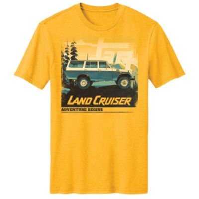 A yellow T-shirt with a graphic of a blue Land Cruiser driving off-road, with ""Land Cruiser"" and ""Adventure Bound"" text below.