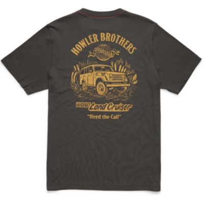 Back of a dark-colored t-shirt featuring a yellow graphic of a Land Cruiser surrounded by plants, with text reading 'HOWLER BROTHERS', a fish illustration, and additional text 'LOYAL Land Cruiser' and 'Heed the Call'