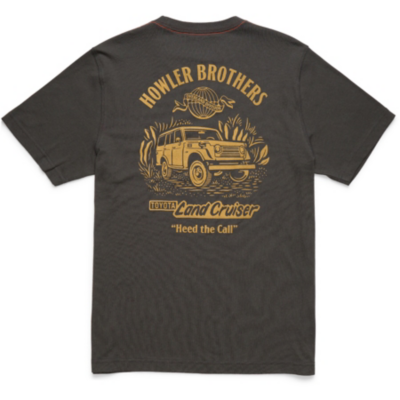 Back of a dark-colored t-shirt featuring a yellow graphic of a Land Cruiser surrounded by plants, with text reading 'HOWLER BROTHERS', a fish illustration, and additional text 'LOYAL Land Cruiser' and 'Heed the Call'