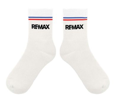 White crew socks with black RE/MAX logos on the front and red and blue stripes around the top.