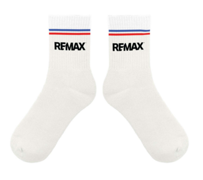 White crew socks with black RE/MAX logos on the front and red and blue stripes around the top.