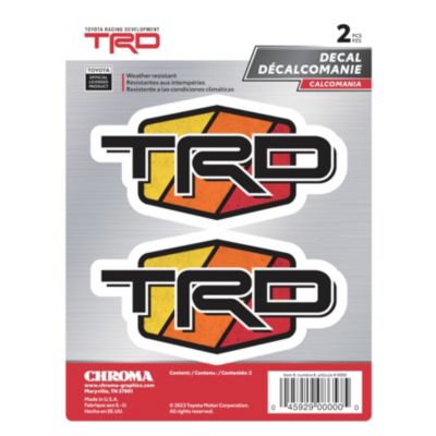 Package containing two TRD decals. Each decal features the letters ""TRD"" in bold, black font with a white outline, set against a geometric background with segments colored red, orange, and yellow.