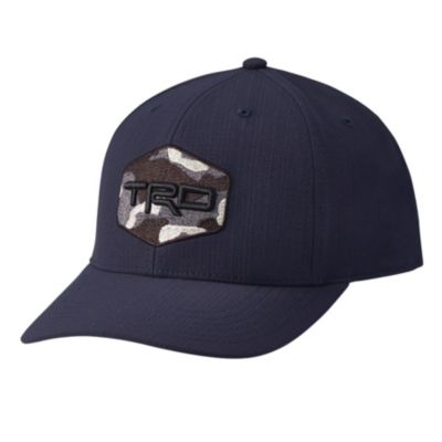  dark blue baseball cap with a curved brim. The front of the cap features a hexagonal patch with a camouflage pattern and the letters 'TRD' embroidered in black