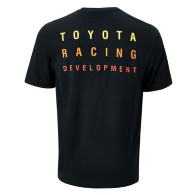 Black tee with with red, orange and yellow design printed on front and back. Front has the outline of the truck with 3 stripes below it. Back has the words Toyota Racing Developtment stacked.