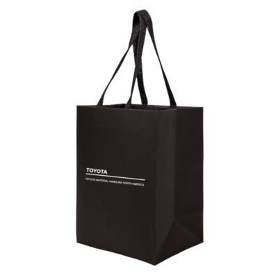 Eco-friendly gift bag made from sugarcane paper, with twisted handles and natural finish.