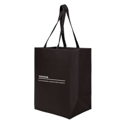 Eco-friendly gift bag made from sugarcane paper, with twisted handles and natural finish.