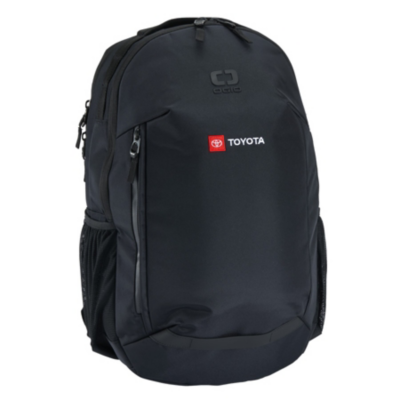 Black backpack with multiple compartments and zippers. Features a red patch with the Toyota logo and embossed 'OGIO' brand name. Mesh pockets on the sides.