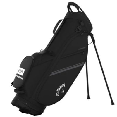 A black Callaway golf bag with a stand. The bag features the Toyota logo on a side pocket and the Callaway logo near the bottom. The bag has multiple compartments and is designed for carrying golf clubs.