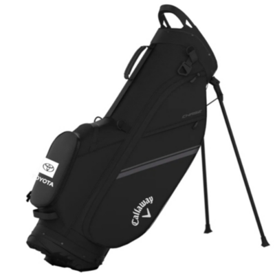 A black Callaway golf bag with a stand. The bag features the Toyota logo on a side pocket and the Callaway logo near the bottom. The bag has multiple compartments and is designed for carrying golf clubs.