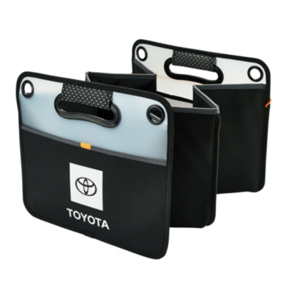 A black and gray collapsible storage organizer with three compartments, featuring the Toyota logo on the front. The organizer has two handles with reinforced grommets.
