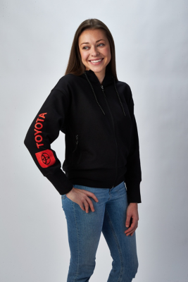 Person wearing a black zip-up hoodie with red 'TOYOTA' text and logo on the left sleeve,